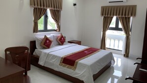 A hotel room with a bed, two nightstands, a desk, and a chair. - Bong Hong Hotel (Sa Dec)