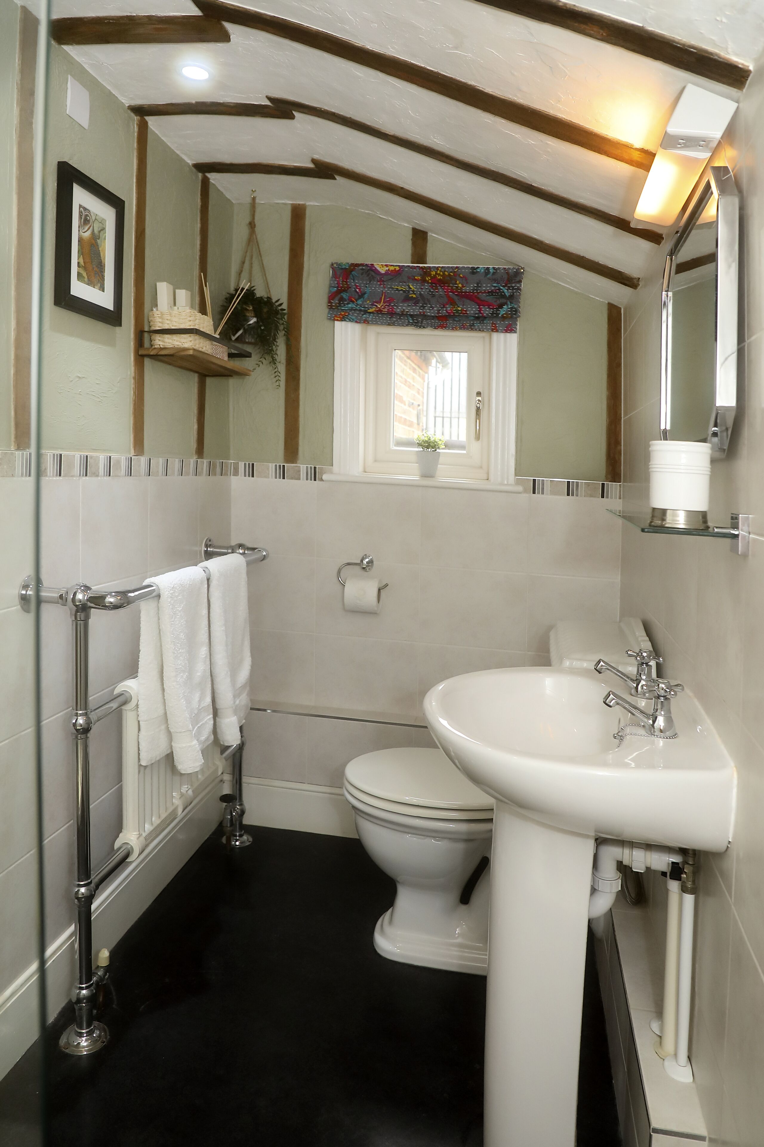 A bathroom with a white sink, toilet, and towel rack.