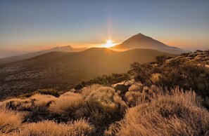 A mountainous landscape with a sunset.