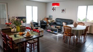 A modern living room with a dining area, a sofa, and a coffee table.