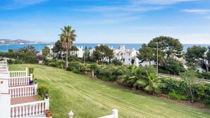A coastal property with a well-maintained lawn, white buildings, and a view of the sea. - Charming seaview apt by Costarentals - Ref 49 (Las Lagunas de Mijas)