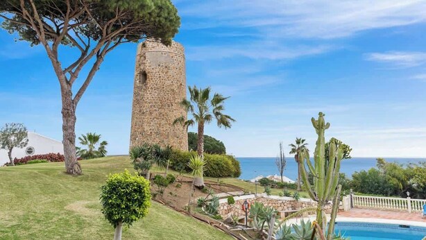 A stone tower, a swimming pool, and a view of the sea. - Charming seaview apt by Costarentals - Ref 49 (Las Lagunas de Mijas)