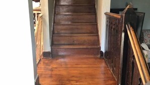 A wooden staircase with a handrail, leading to an upper floor. - Cozy 3 Bedroom Port Clinton House (Port Clinton)