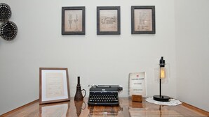A desk with a typewriter, framed documents, a vintage lamp, and a sign. - Modern Industrial, 12 min walk to Bridge St. (Phoenixville)