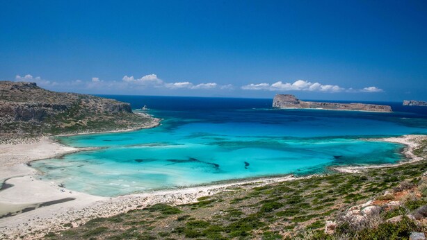 A coastal landscape with clear turquoise waters, rocky cliffs, and a sandy beach. - VILLA KORE ELAFONISSI (Keramoti)