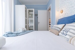 A bedroom with a large bed, a wardrobe, and a closet.