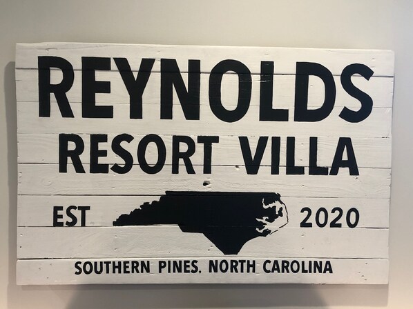 A sign for Reynolds Resort Villa with a map of North Carolina and the establishment year 2020.