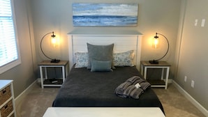 A bedroom with a bed, two bedside tables with lamps, a bench, a painting, and a window. - Reynolds Villa- Golf/Couples Retreat (Southern Pines)