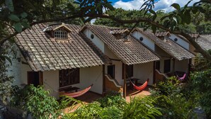 A row of traditional houses with tiled roofs, surrounded by lush greenery. - Hostería Paraíso (Vilcabamba)
