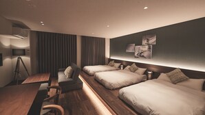 A modern hotel room with a wooden floor, a desk, a sofa, and two single beds. - ReLA Higashimatsudo (Matsudo)