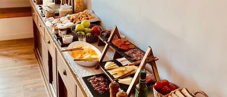 Un bufé de desayuno con diversos alimentos y un espejo en la pared.