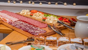 A buffet table with various food items including meats, cheeses, and vegetables. - Kozjanski dvor (Kozje)