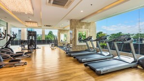 A modern gym with treadmills, elliptical machines, and free weights. - Panoramic Sea, City And Mountain Views by City Garden Tower (Pattaya)