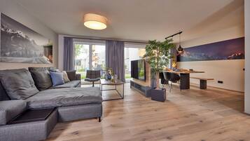 Deluxe Apartment | Living area | 55-inch Smart TV with cable channels, TV, Netflix