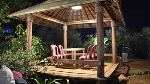 A gazebo with a table and chairs, surrounded by greenery. - I-Camp Resort (Wai)