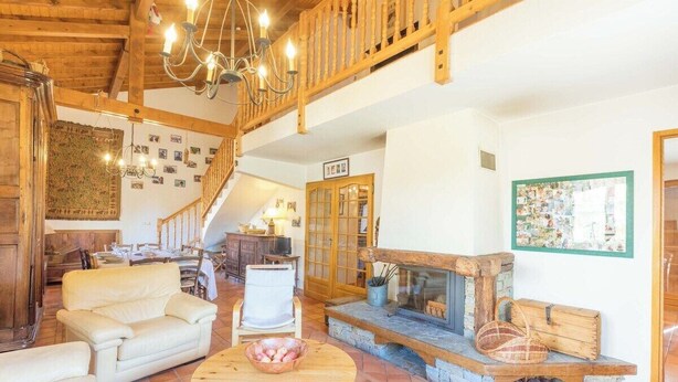 A spacious living area with a fireplace, wooden furniture, and a staircase. - Chalet Doire, spacious 6 bedroom chalet (Montgenèvre)