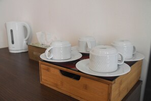 A wooden tray with white cups and saucers, a white coffee maker, and a tissue box on a wooden table. - Hotel Du Palais Bastia Centre (Bastia)