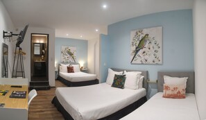 A hotel room with two beds, a desk, and a mirror. There are wall-mounted paintings of birds and flowers. - Hotel Du Palais Bastia Centre (Bastia)