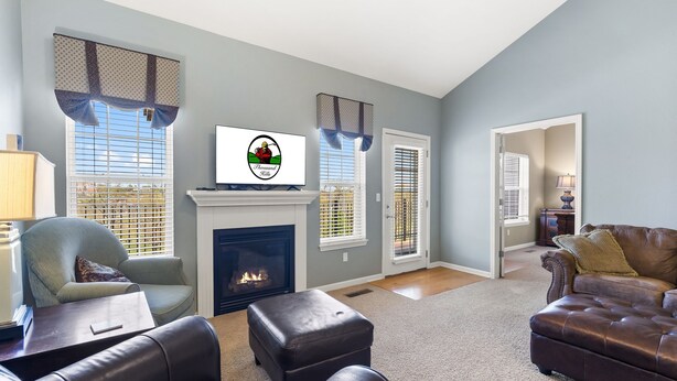 A living room with a fireplace, a television, and two sofas. - Branson Vacation Rental | Game Room | Garage | Sleeps 8 (Branson)