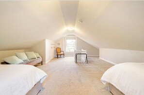 Relax in this cozy loft-style bedroom with a large bed and comfortable seating area.