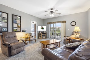 A living room with a recliner, leather sofa, wooden coffee table, and a television. - 2 Bedroom, 2 Bathroom Golf Condo feat. Covered Balcony with BeautifulCourse View (Branson)