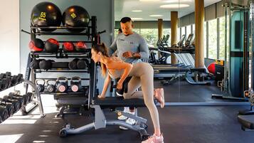 A gym with exercise equipment, treadmills, and weightlifting stations.