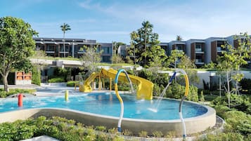 Relax by the pool surrounded by lush greenery and enjoy a fun water slide.