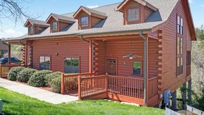 A log cabin with a porch, multiple windows, and a chimney. - Woodland Retreat for 6 | Cozy Fireplace + Pool Access (Branson)