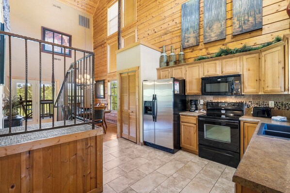 Enjoy cooking in this well-equipped kitchen with a refrigerator, microwave, and oven.