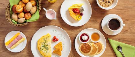 A breakfast setting with various dishes and drinks.