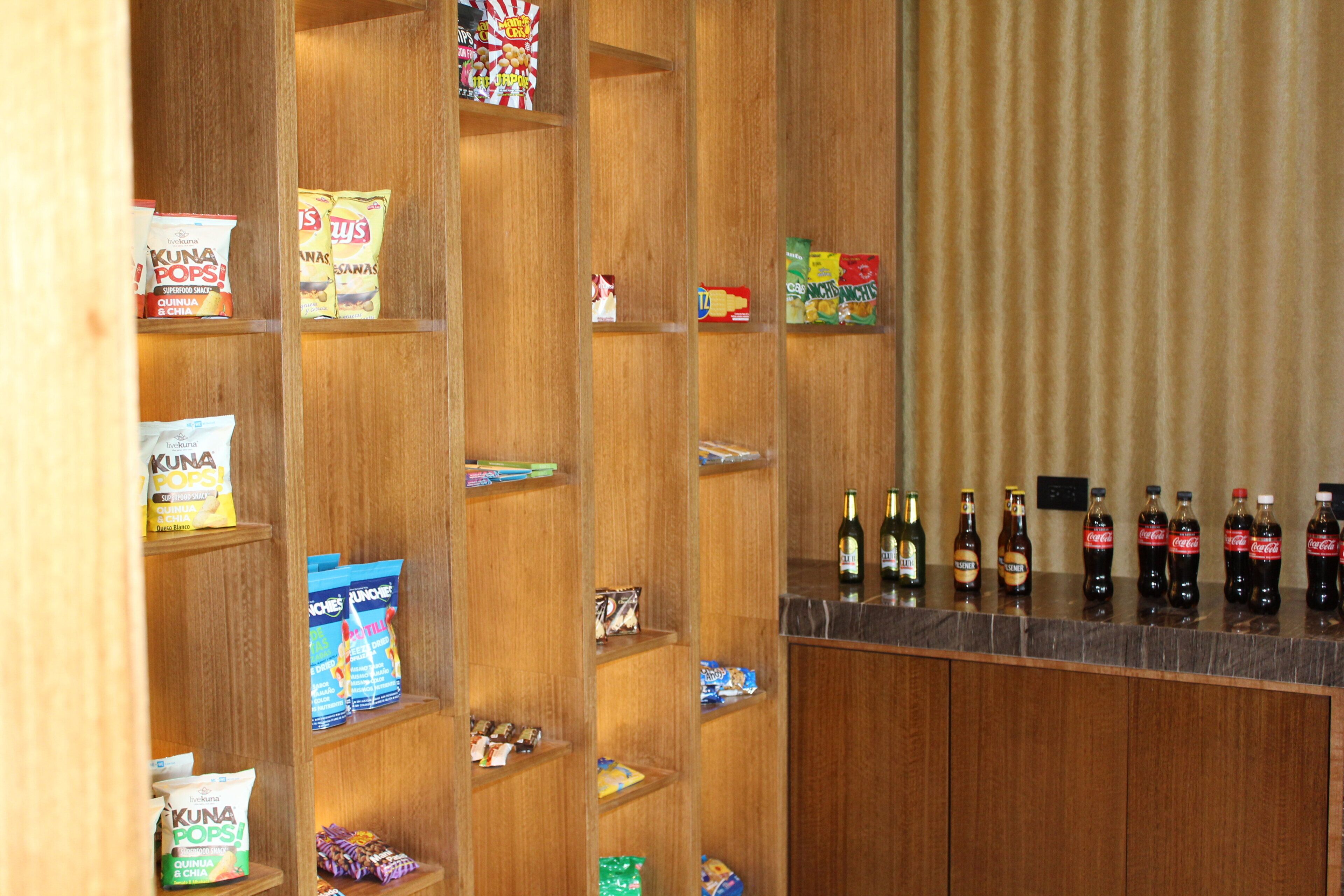 A bar area with shelves stocked with snacks and beverages.