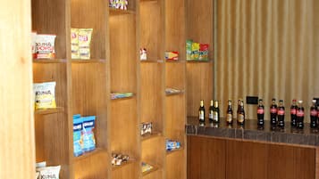 A bar area with shelves stocked with snacks and beverages.