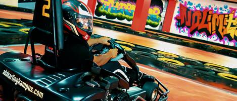 A go-kart track with graffiti on the walls.