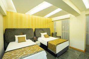 A hotel room with two beds, a large window with curtains, and a ceiling with skylights. - Continent Luxury Suites Sakarya (Serdivan)