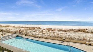 A swimming pool with a view of the beach and ocean.