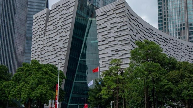 A modern building with a unique angular design, surrounded by trees and other tall buildings. - City Comfort Inn Guangzhou Tiyu West Road Metro Station (Guangzhou)