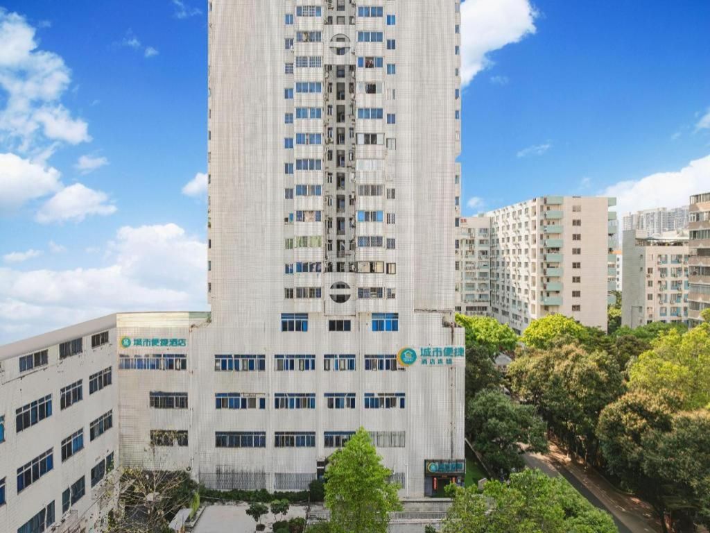 A high-rise building with multiple floors, large windows, and a sign indicating it is a hospital.