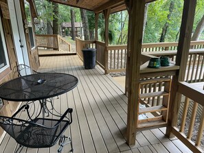 Enjoy a peaceful outdoor space with a round table and chair, surrounded by trees.