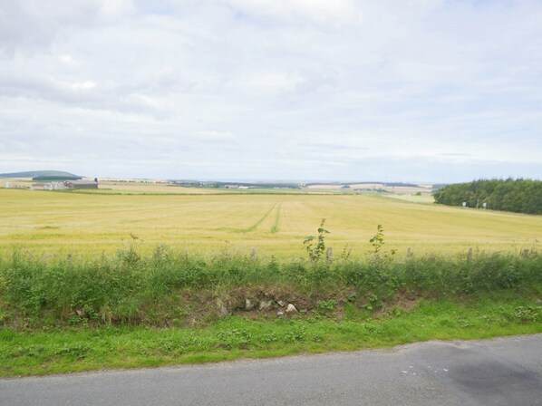 A rural landscape with a road in the foreground and fields in the background. - 2 bedroom accommodation in Cornhill, near Portsoy (Cornhill, near Portsoy)