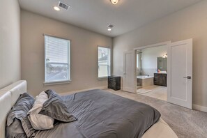 A bedroom with a bed, a dresser, and a closet.
