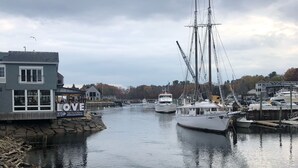 A harbor with boats, a building with a 'LOVE' sign, and a dock. - Make your summer memories here! (Wells)