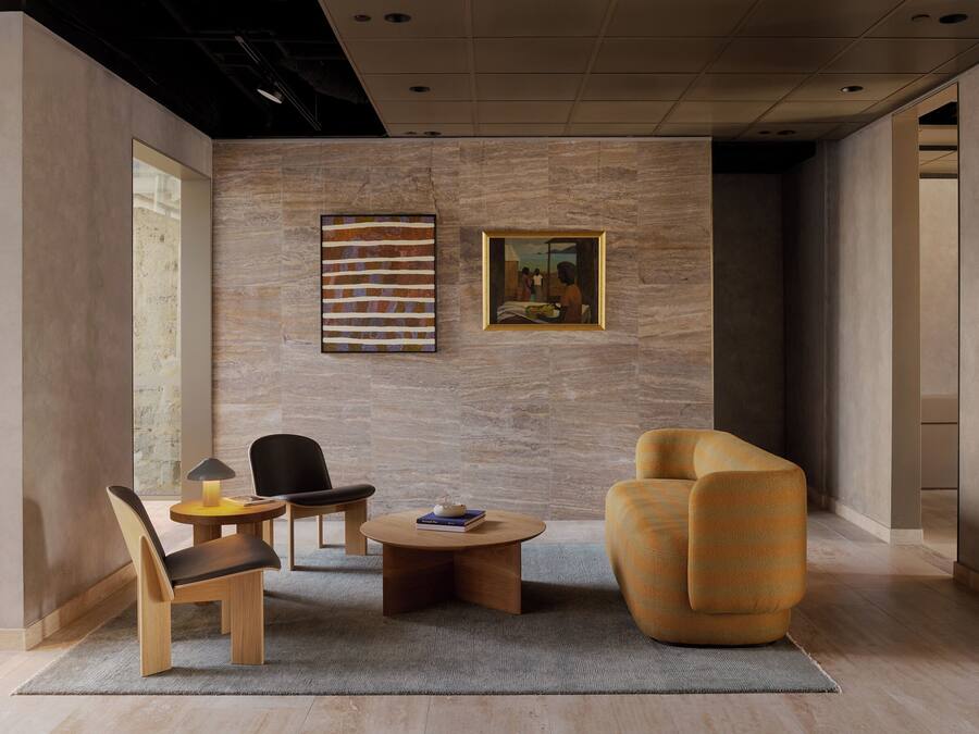 A modern living room with a sofa, armchair, and a coffee table.