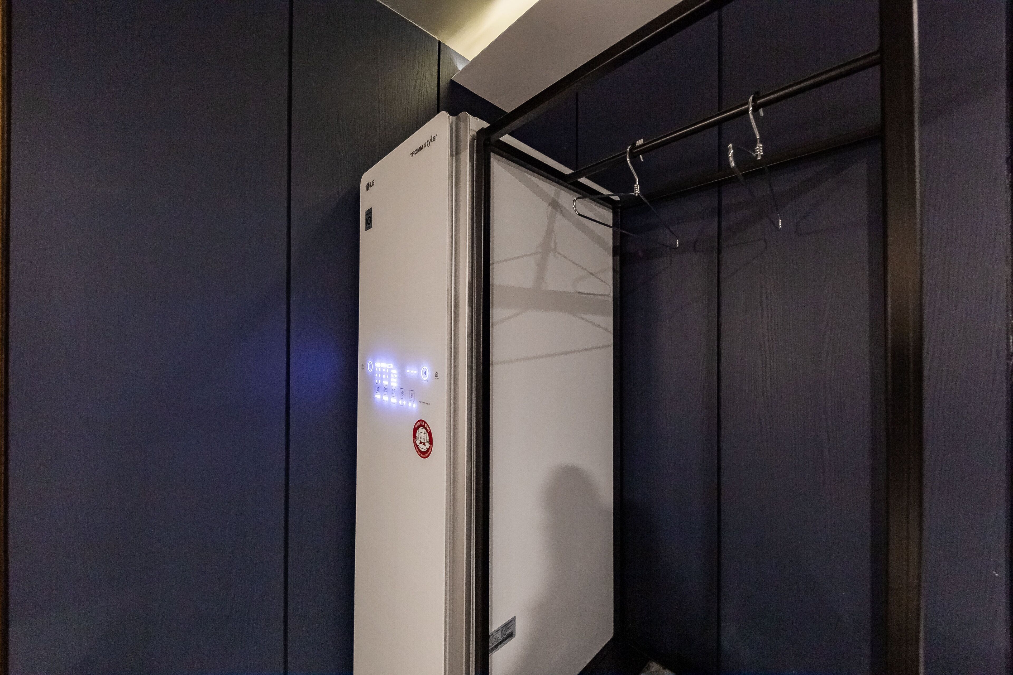 A modern elevator with a digital display and a no-smoking sign.