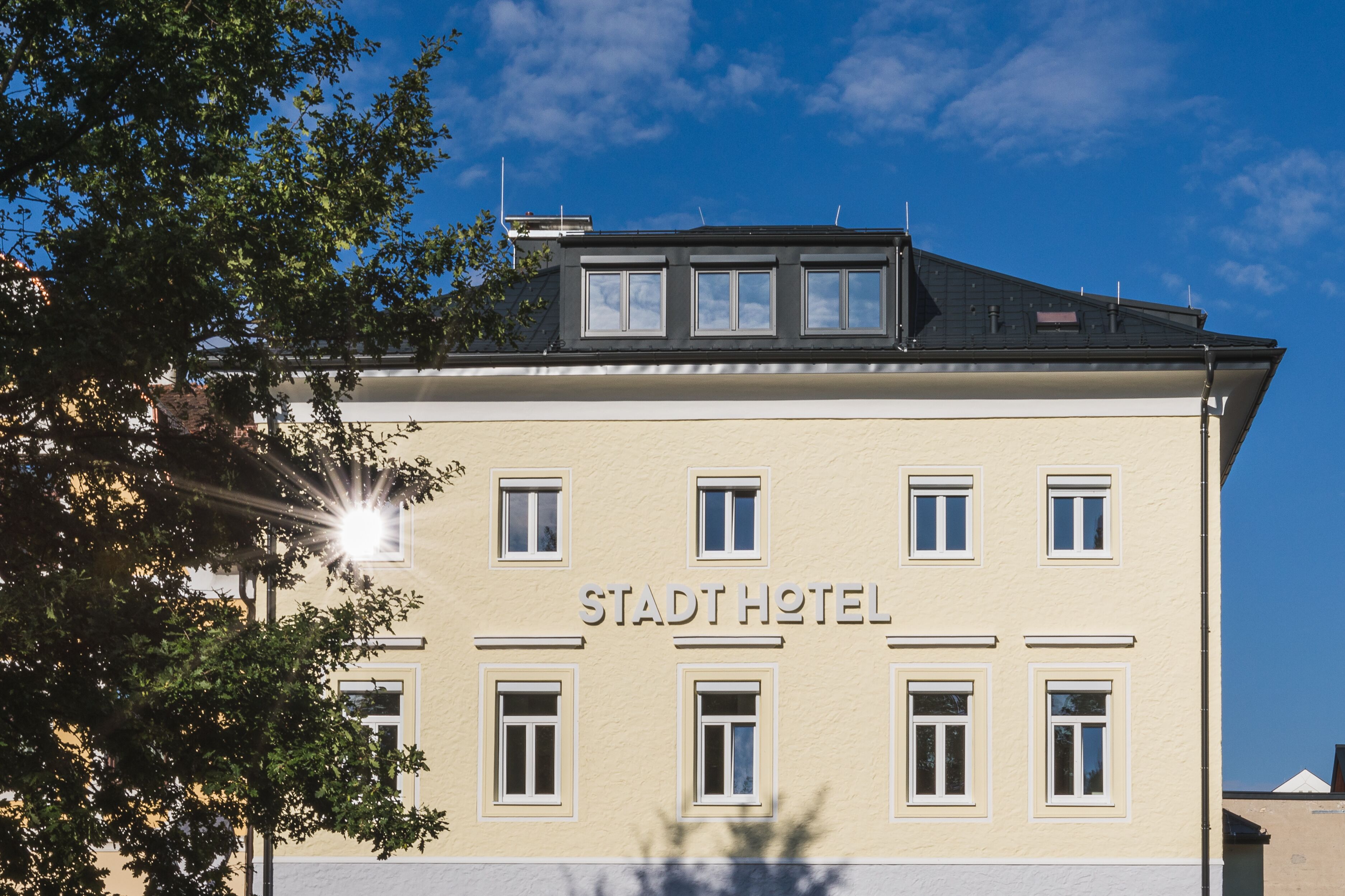 A building with the sign "STADTHOTEL" indicating it is a hotel.