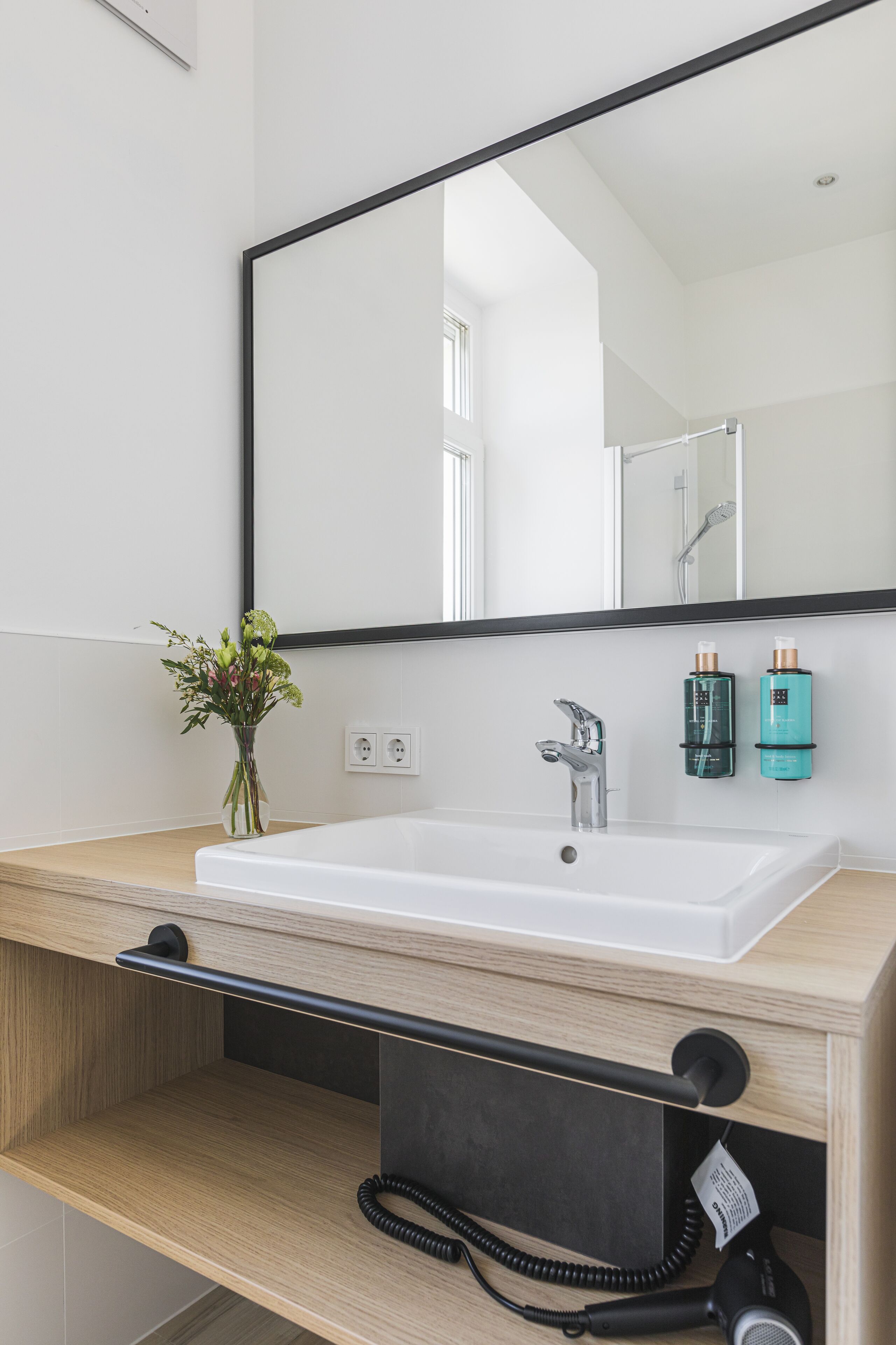 designer toiletries, hair dryer, towels, soap