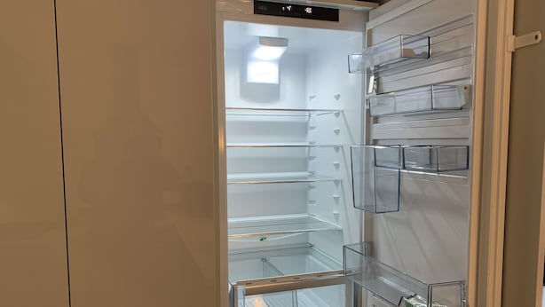 A modern, empty refrigerator with clear shelves and a digital display. - Stylish and Immaculate 2-bed Apartment in Leigh (Leigh)