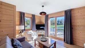 A modern living room with a sofa, coffee table, and TV.