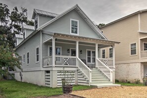 Stunning two-story home with a charming front porch and beautifully manicured lawn.