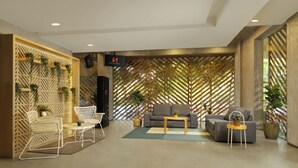 Un vestíbulo moderno con un sofá, sillas, una mesa de centro y plantas decorativas.