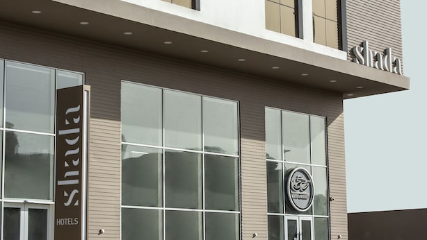A hotel facade with large windows, a prominent 'Shada Hotels' sign, and a logo indicating a 'Shada Eatery' on the right. - Shada Hotel Shatea (Jeddah)